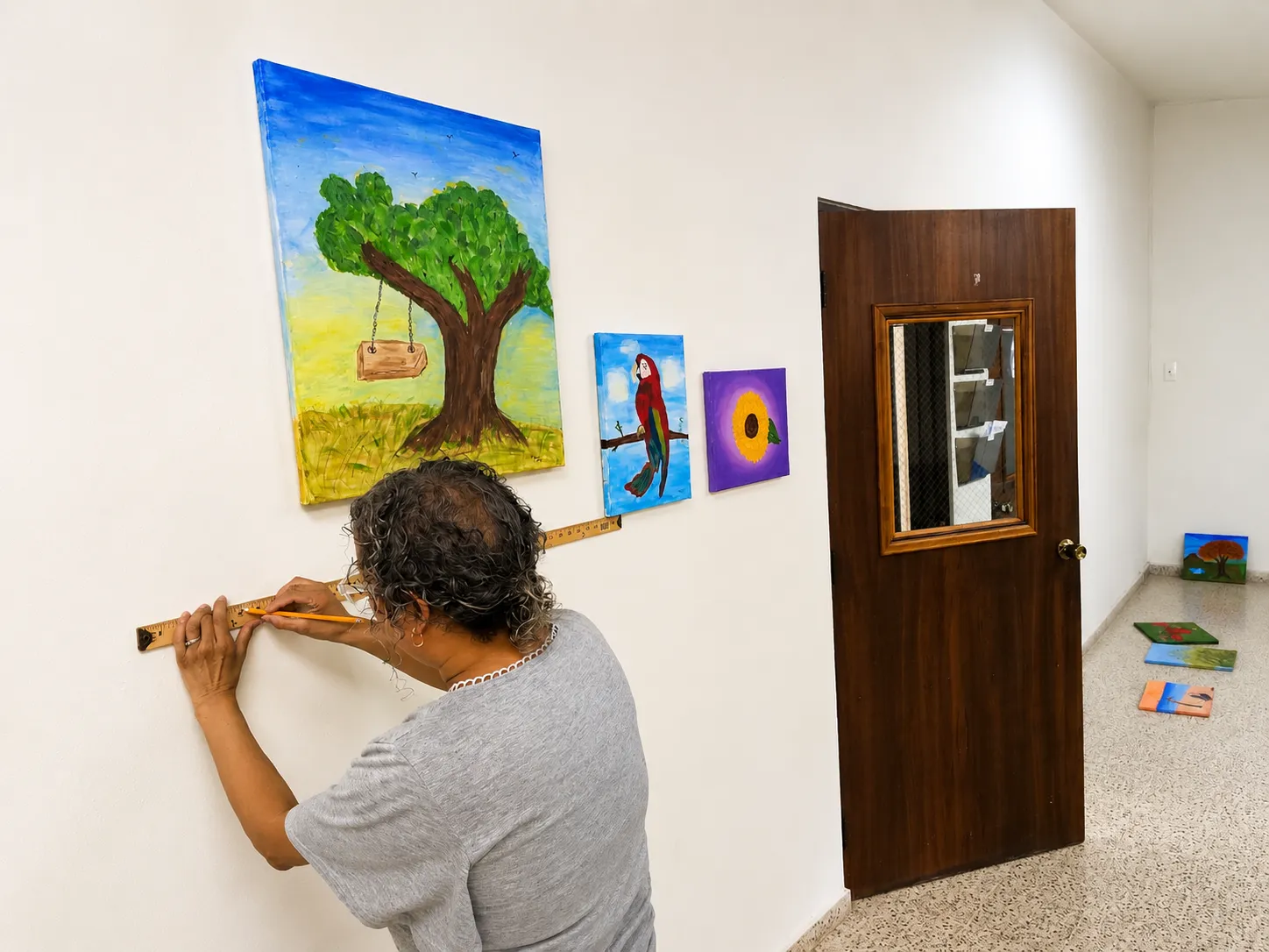 La Profa. Areli M. Nieves Montañez alinea las obras antes de la inauguración.